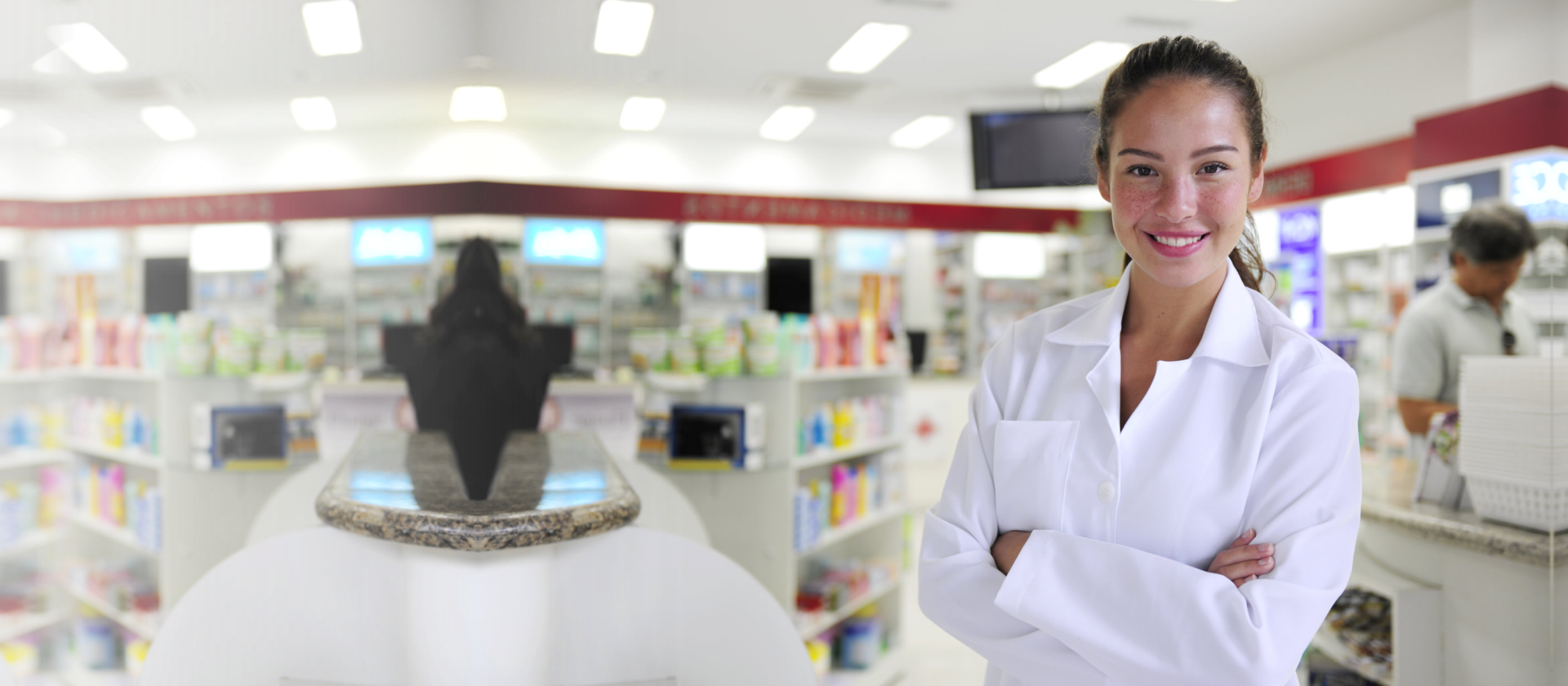 Portrait of a female pharmacist at pharmacy smiling