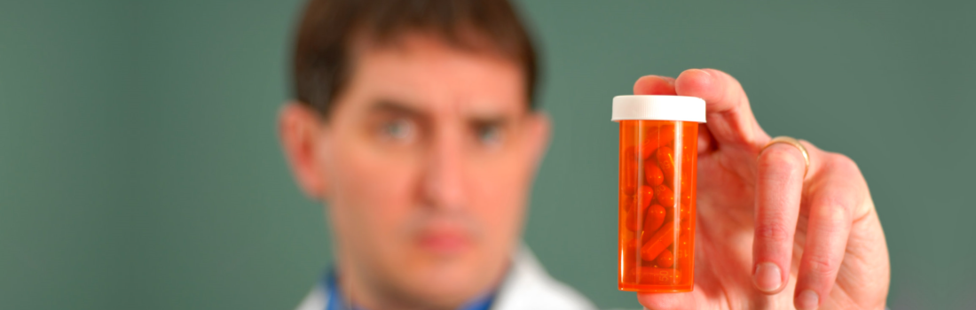 pharmacist showing a medicine bottle